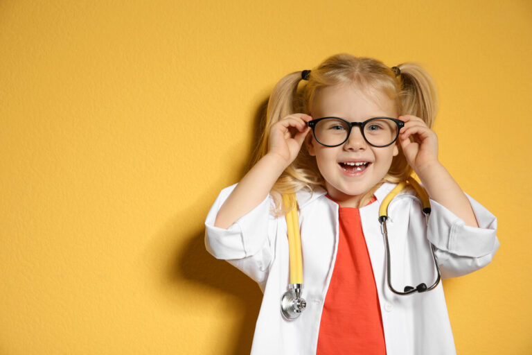 Cute child in doctor coat with stethoscope on color background